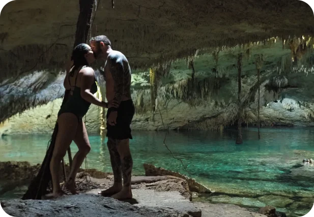 couple kissing in a cave with their bathing suits