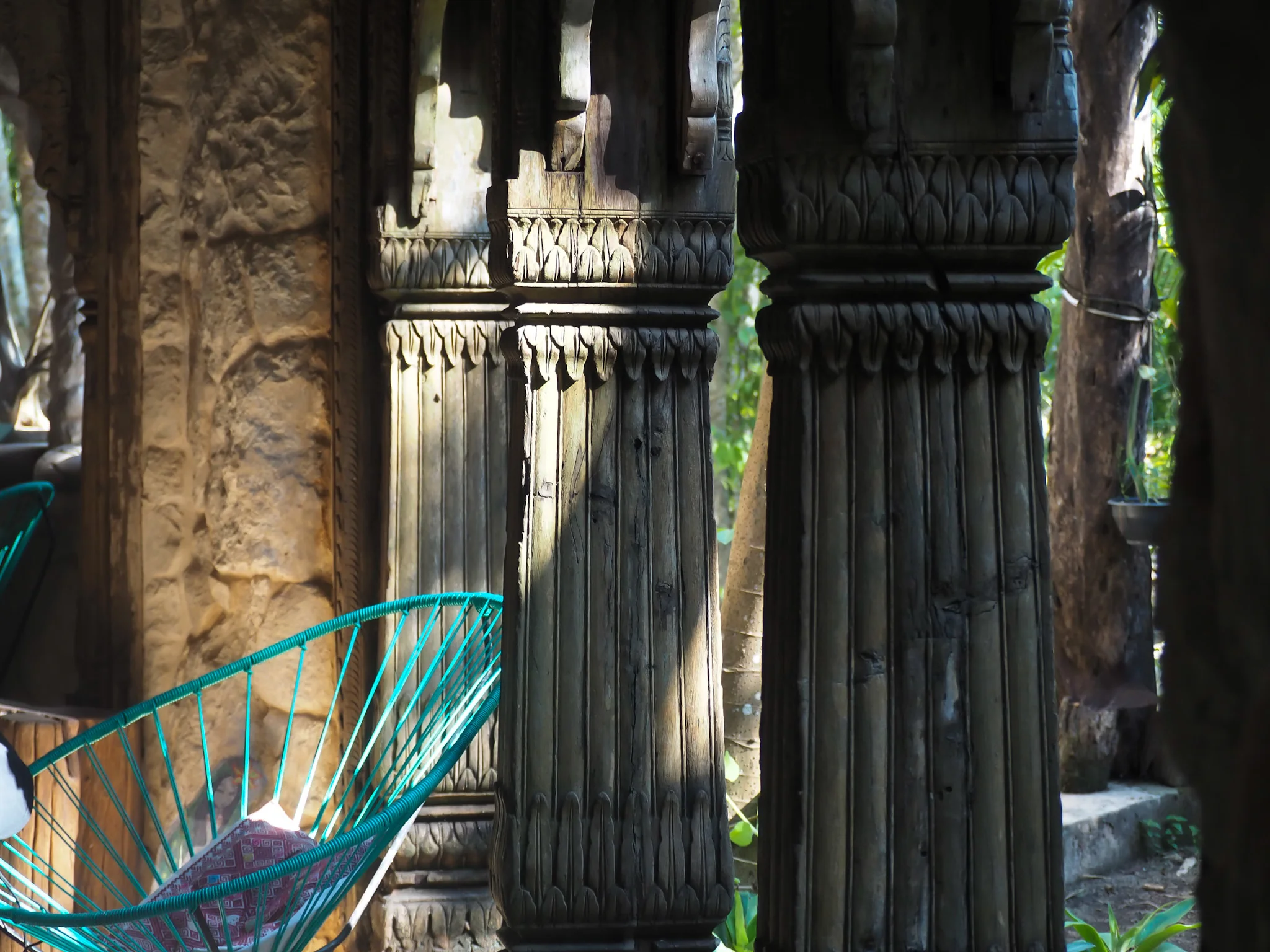 chair next to pillars in a natural setting in a retreat
